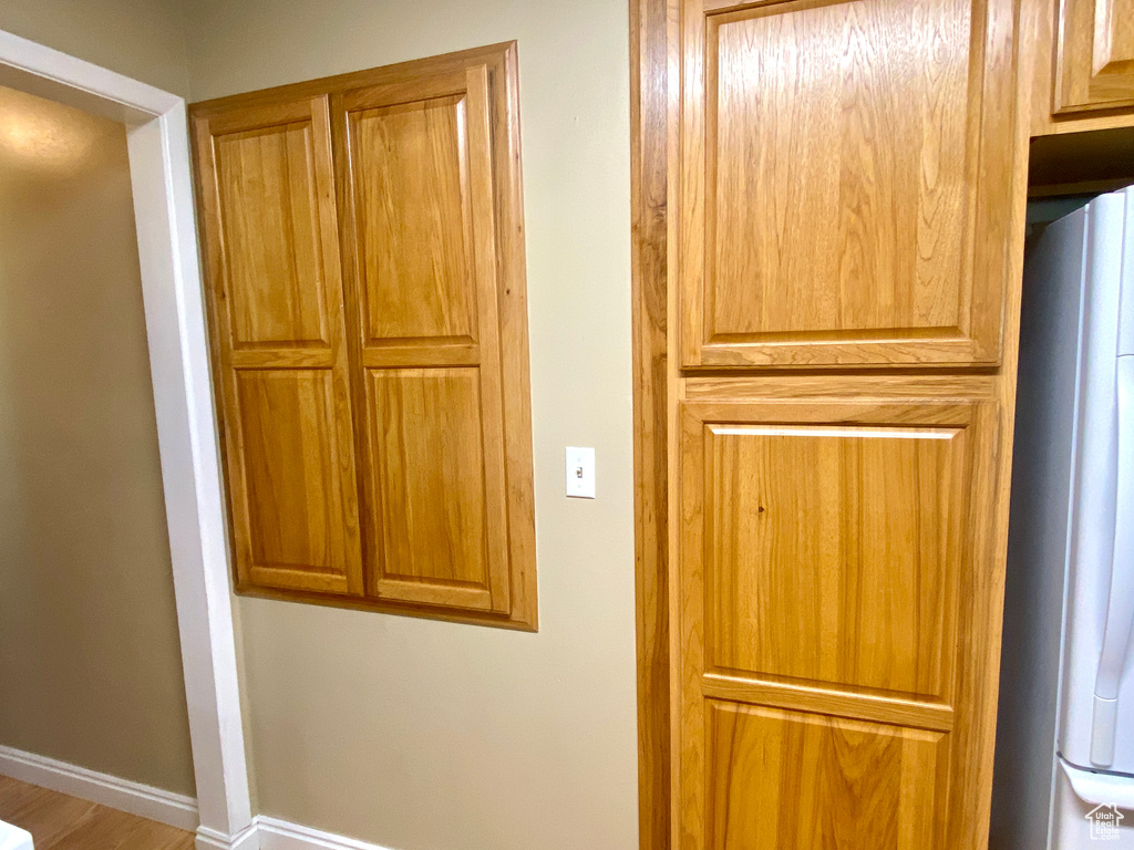 Detailed view of fridge and baseboards