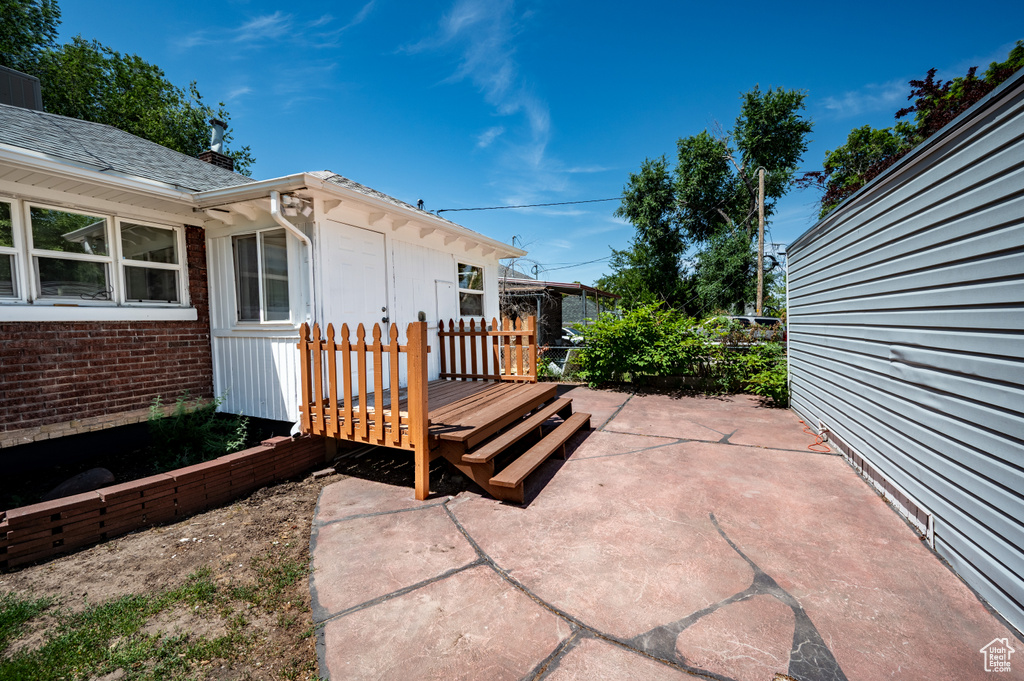View of patio with a wooden deck
