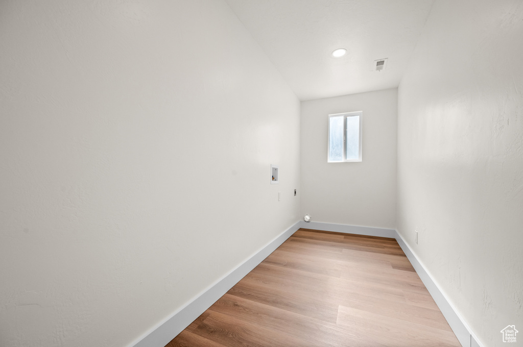 Spare room featuring baseboards and light wood finished floors
