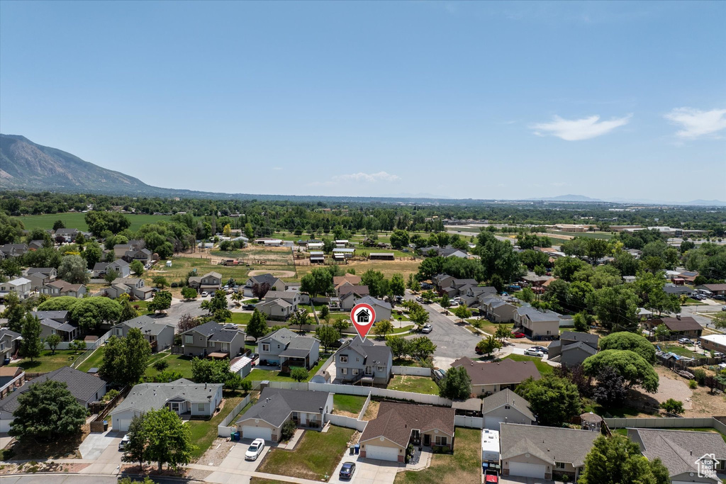 Aerial view of residential area featuring a mountainous background