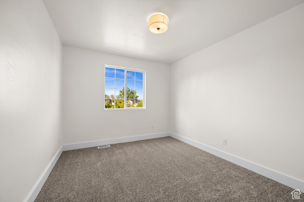 Unfurnished room featuring carpet and baseboards