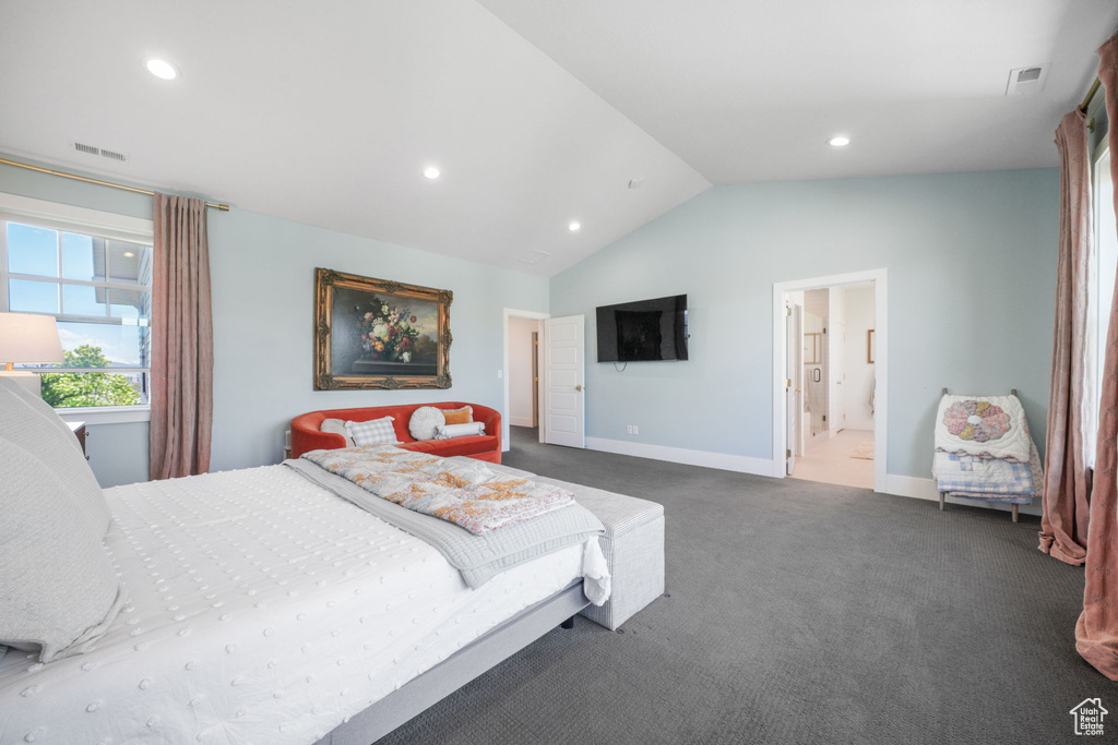 Bedroom featuring dark colored carpet, vaulted ceiling, baseboards, recessed lighting, and ensuite bathroom
