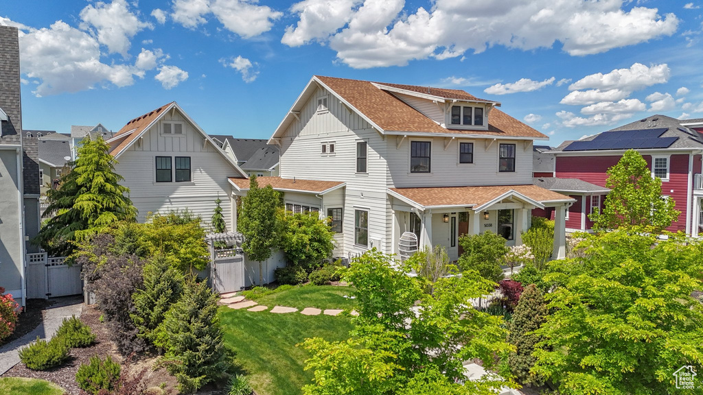 View of front of house featuring board and batten siding and a shingled roof