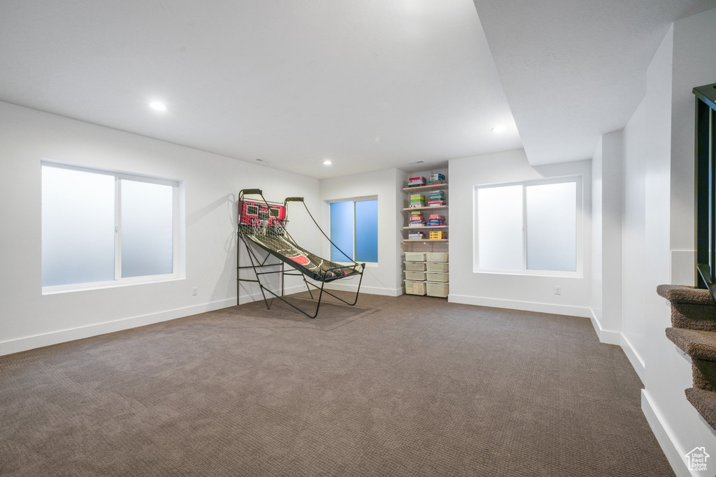 Rec room with dark carpet, baseboards, and recessed lighting