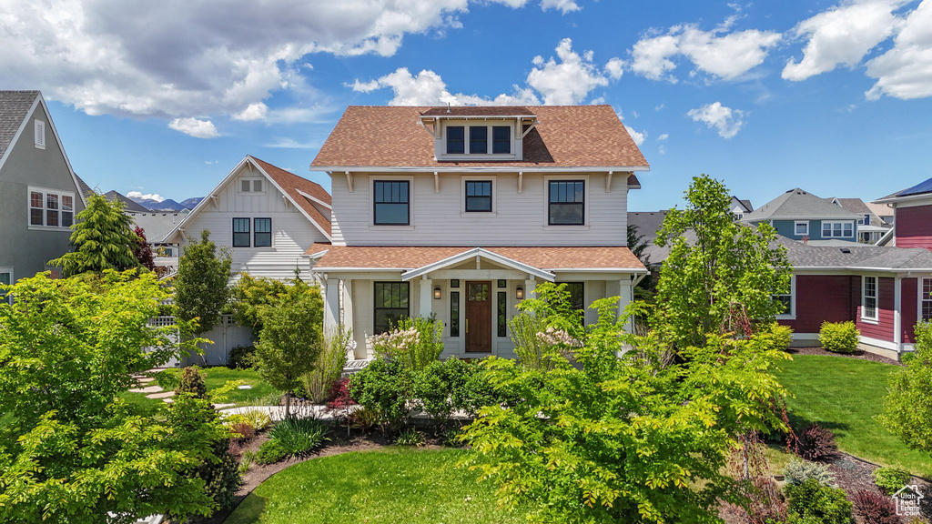 American foursquare style home with a shingled roof