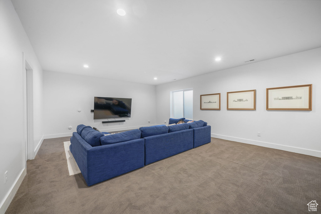 Living room with carpet floors, recessed lighting, and baseboards