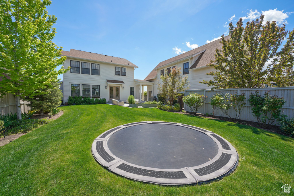 Back of property with a trampoline