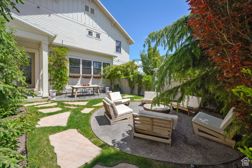 View of patio featuring an outdoor living space and fence