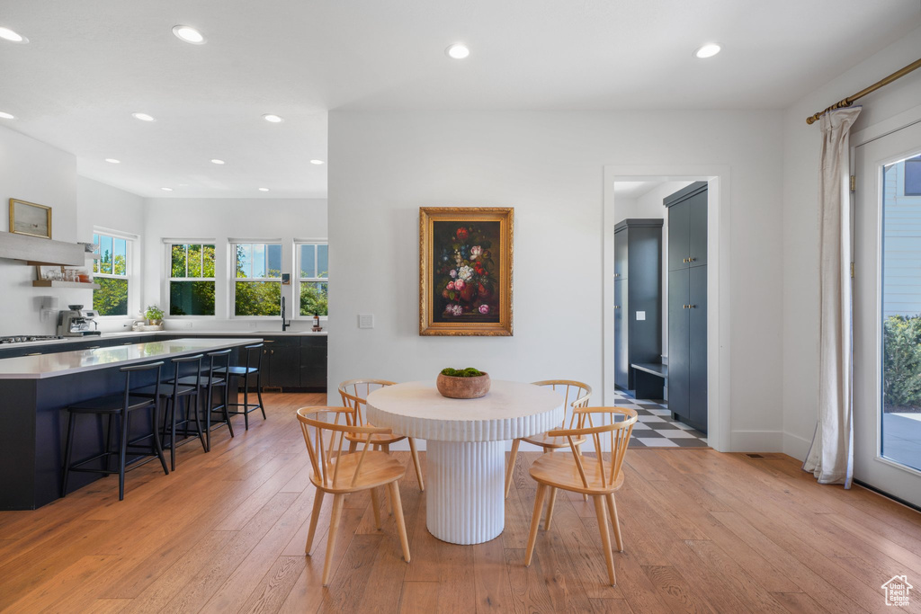 Dining area featuring light wood-style floors and recessed lighting