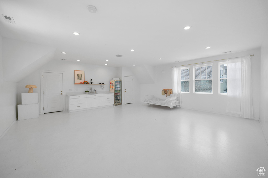 Sitting room featuring bar, recessed lighting, and finished concrete flooring