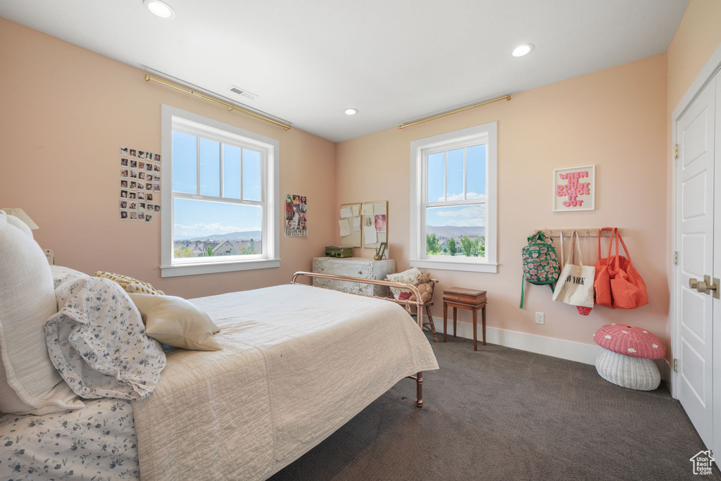 Carpeted bedroom with multiple windows, recessed lighting, and baseboards