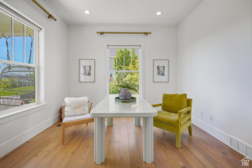 Home office with baseboards, light wood-type flooring, and recessed lighting