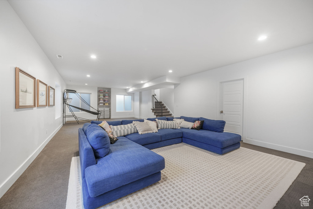 Living room featuring stairway, carpet floors, recessed lighting, and baseboards