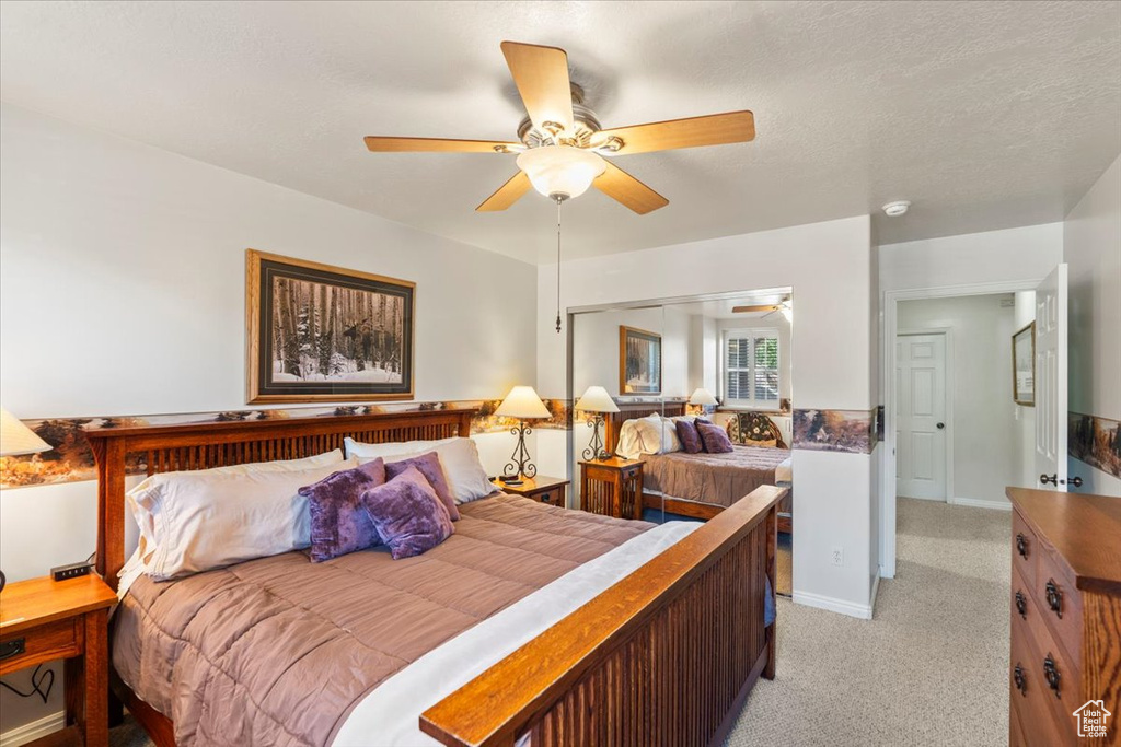 Bedroom featuring light colored carpet and ceiling fan