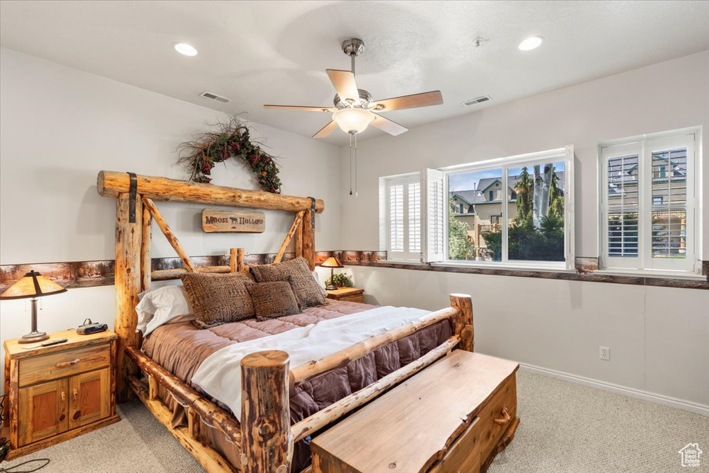 Bedroom with light carpet, visible vents, and recessed lighting