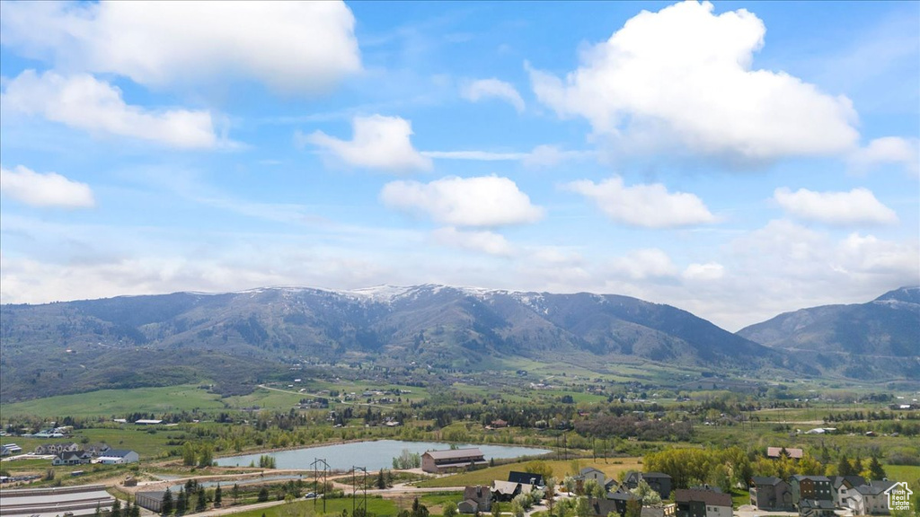 Property view of mountains featuring a water view