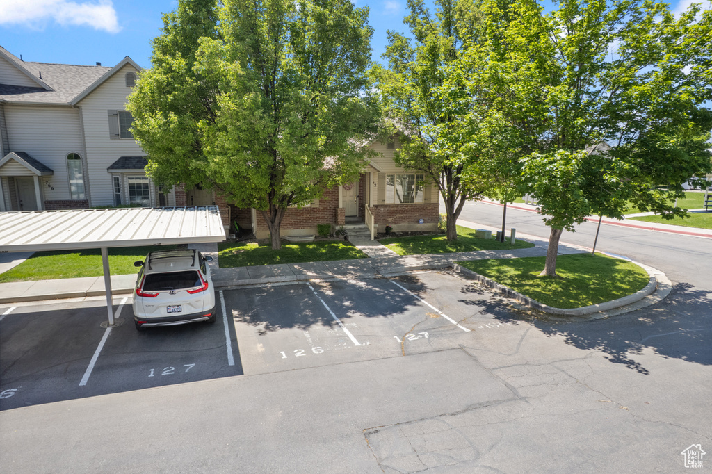 View of front of house featuring uncovered parking and brick siding