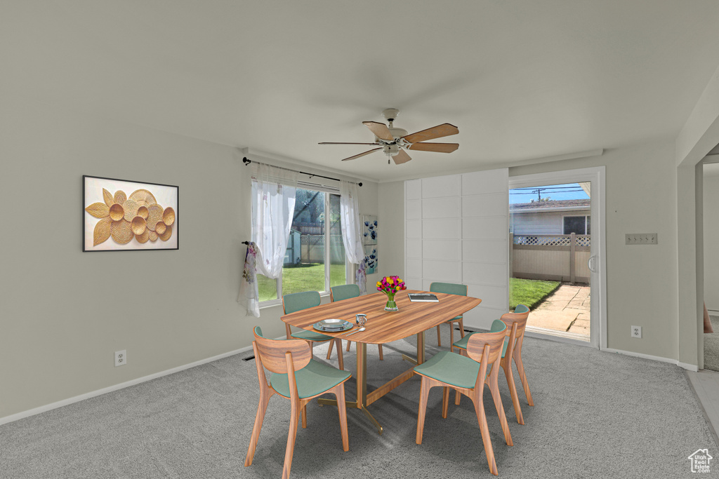 Dining room featuring a ceiling fan, carpet, and baseboards