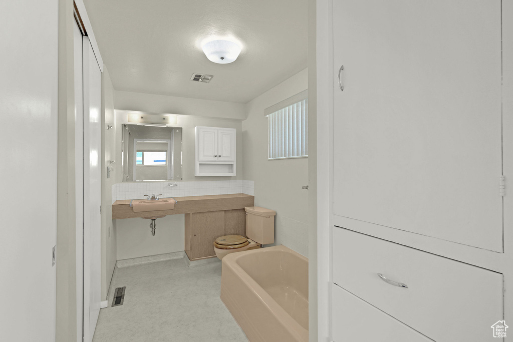 Full bathroom with a sink and a garden tub
