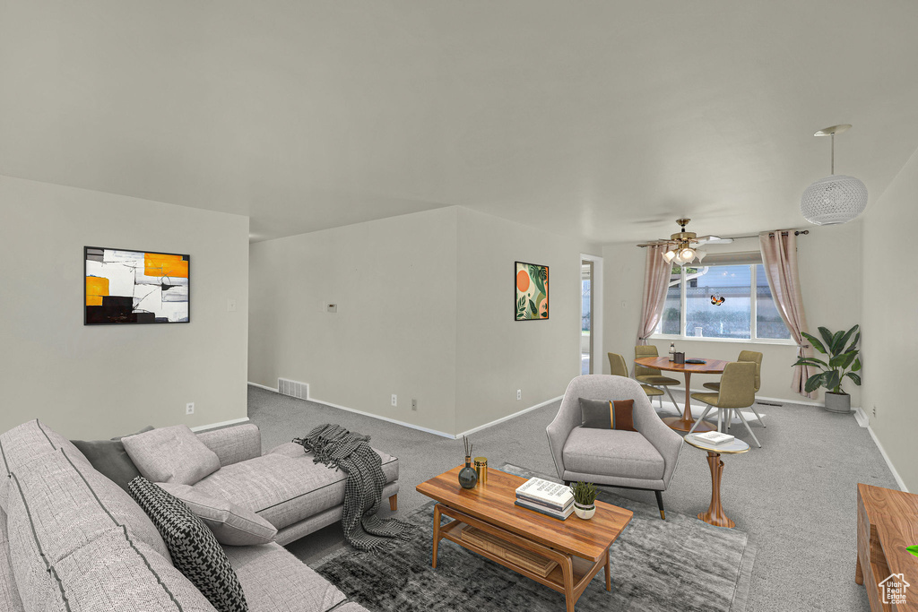 Living room featuring baseboards, carpet, and a ceiling fan