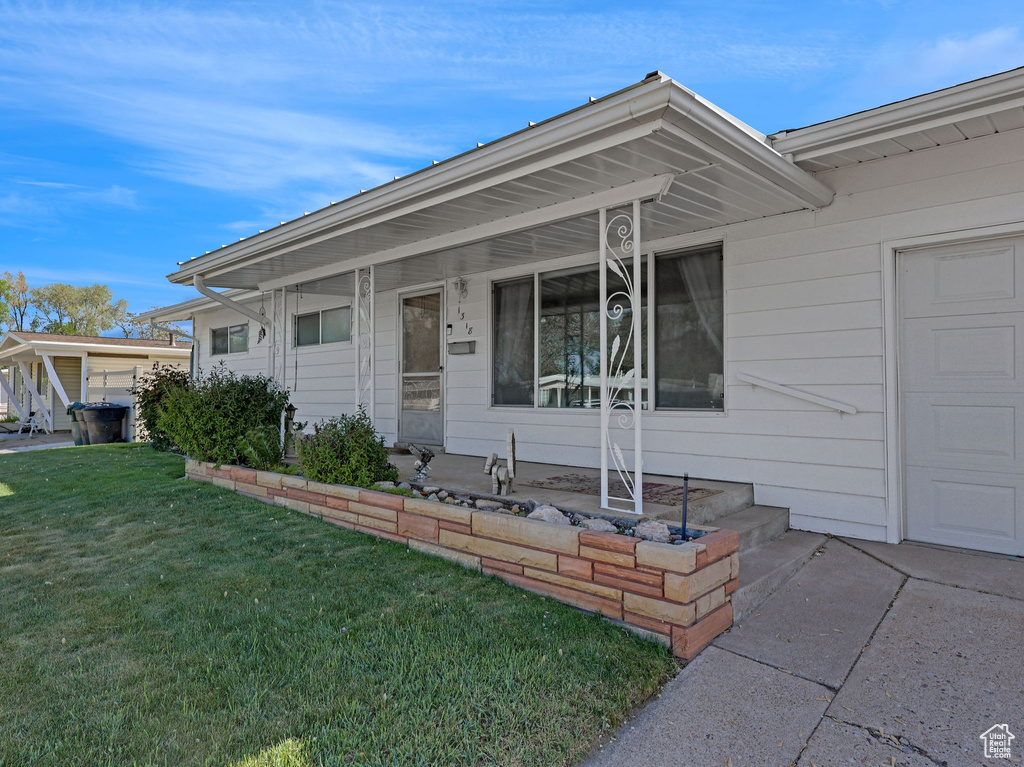 View of front of home with a front yard and a porch