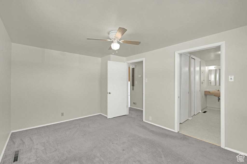 Unfurnished bedroom featuring carpet and baseboards
