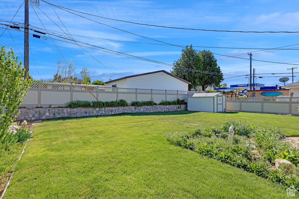 View of yard with a storage shed and an outdoor structure
