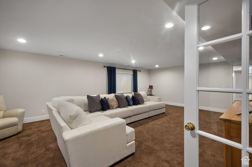 Living room featuring carpet floors, recessed lighting, and baseboards