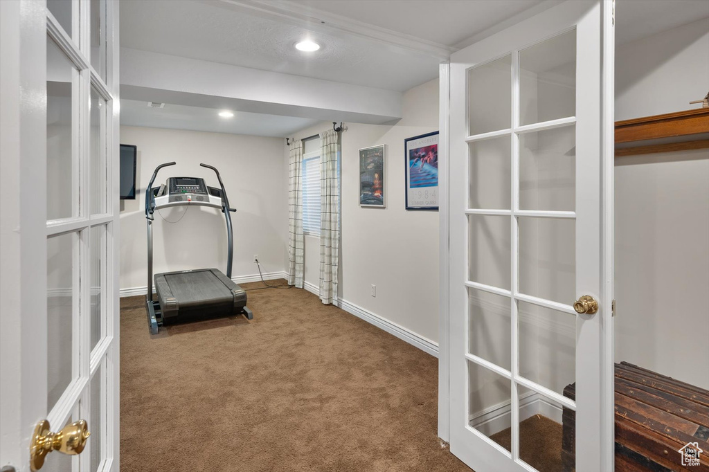 Exercise room featuring carpet floors, french doors, baseboards, and recessed lighting