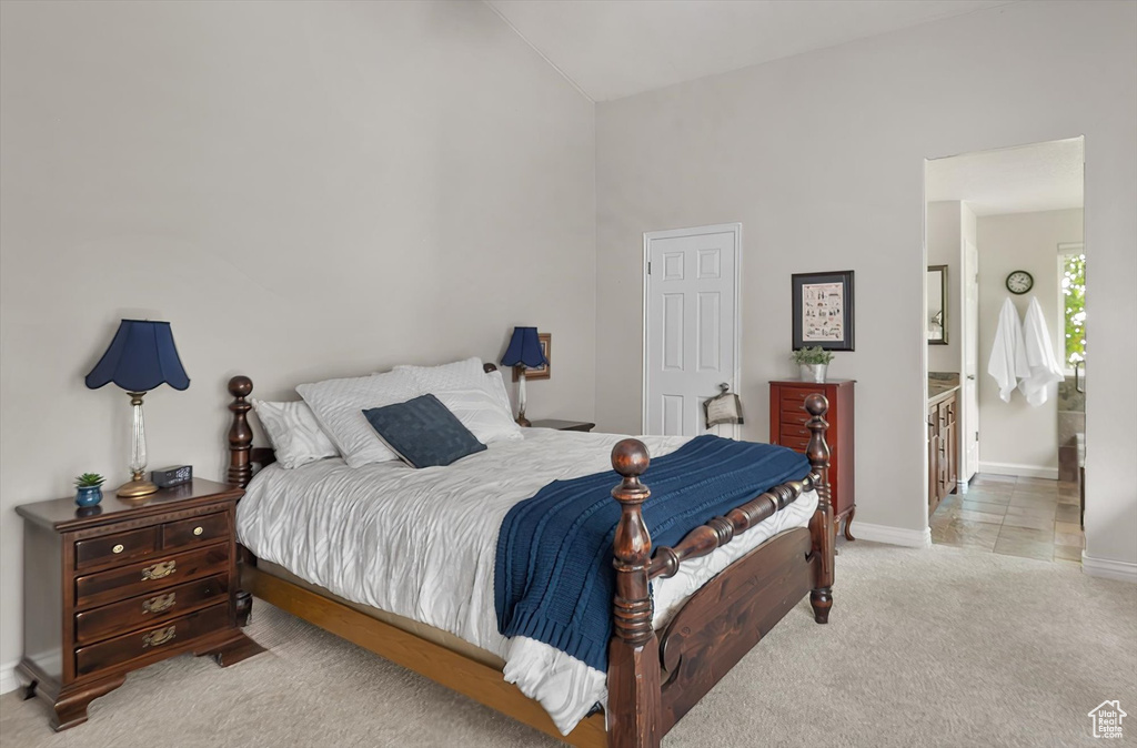 Carpeted bedroom with baseboards and lofted ceiling
