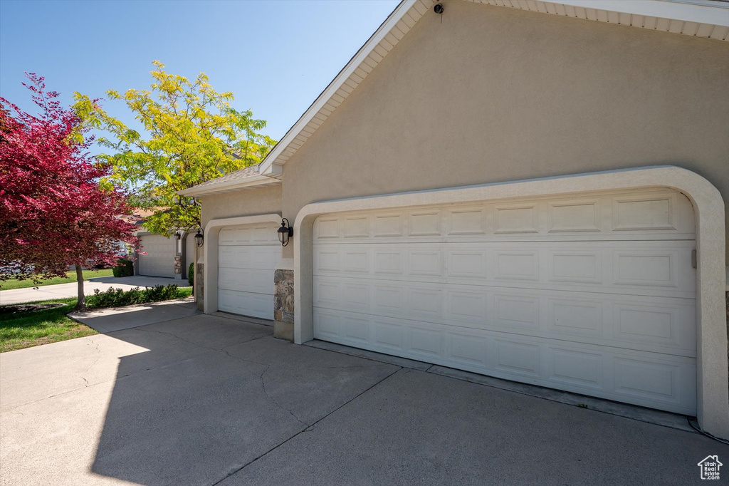 Garage featuring concrete driveway