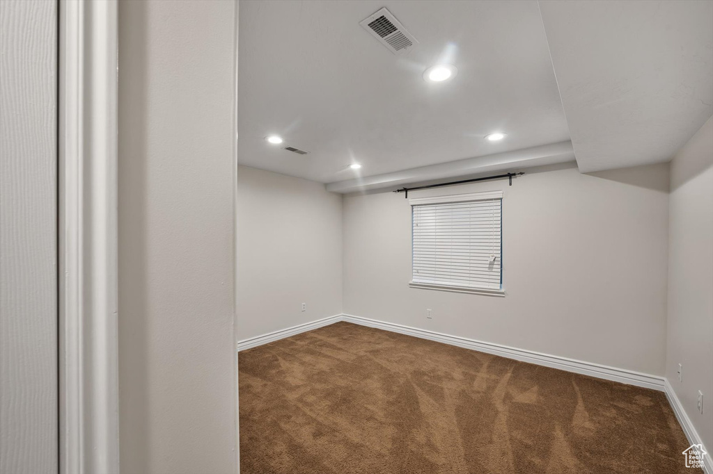 Unfurnished room featuring carpet floors, baseboards, and recessed lighting