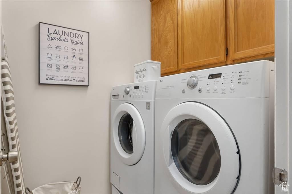 Laundry room featuring cabinet space and separate washer and dryer