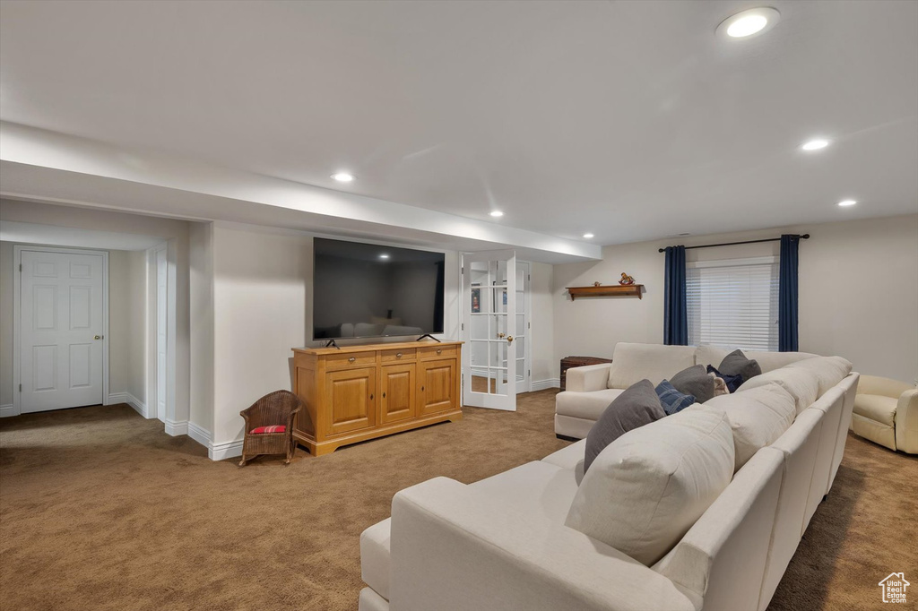Carpeted living area with recessed lighting and baseboards