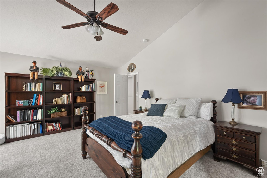 Carpeted bedroom featuring a ceiling fan and high vaulted ceiling