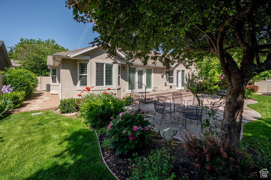 Back of property featuring stucco siding, a patio, and french doors