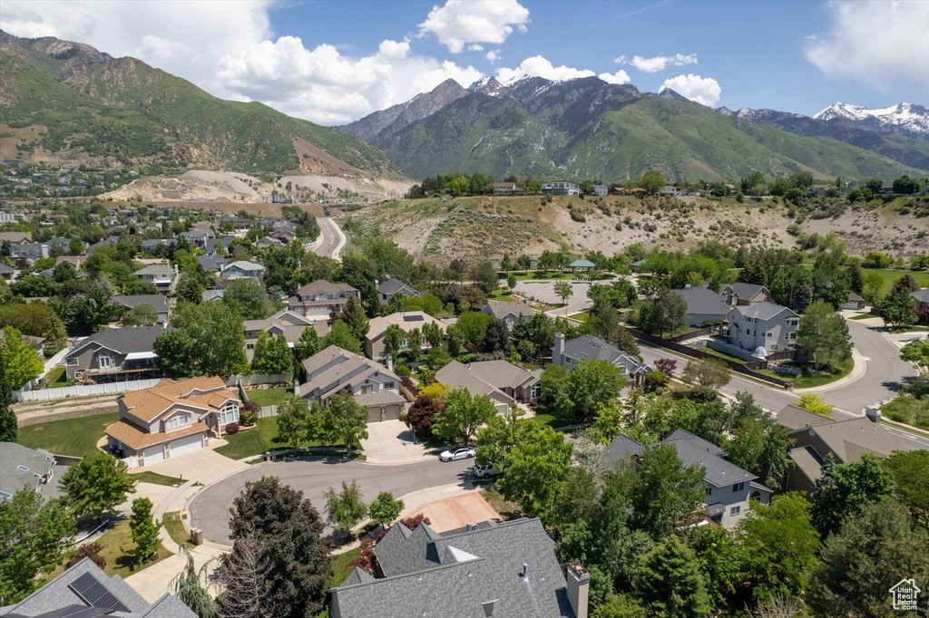 Aerial view of residential area featuring a mountainous background