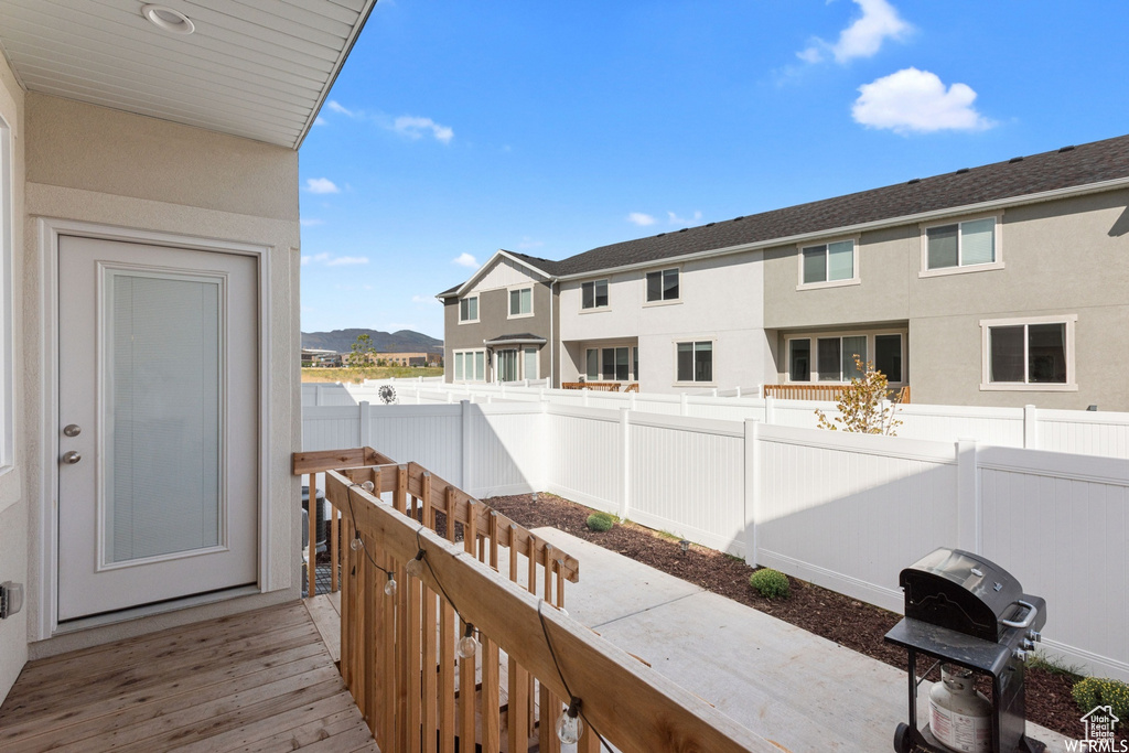 View of wooden balcony featuring a wooden deck and area for grilling