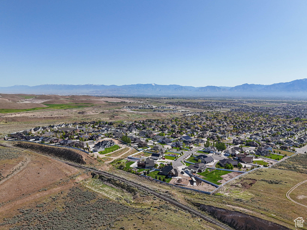 Aerial overview of property's location featuring a mountain backdrop and nearby suburban area