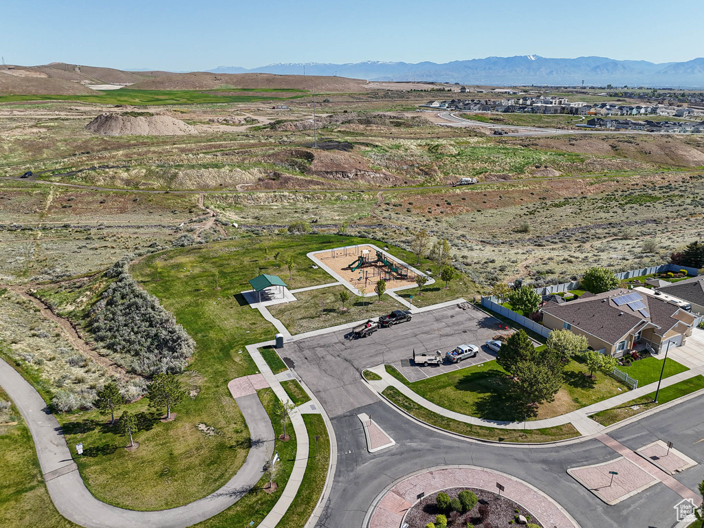 Aerial view of property and surrounding area featuring a mountainous background