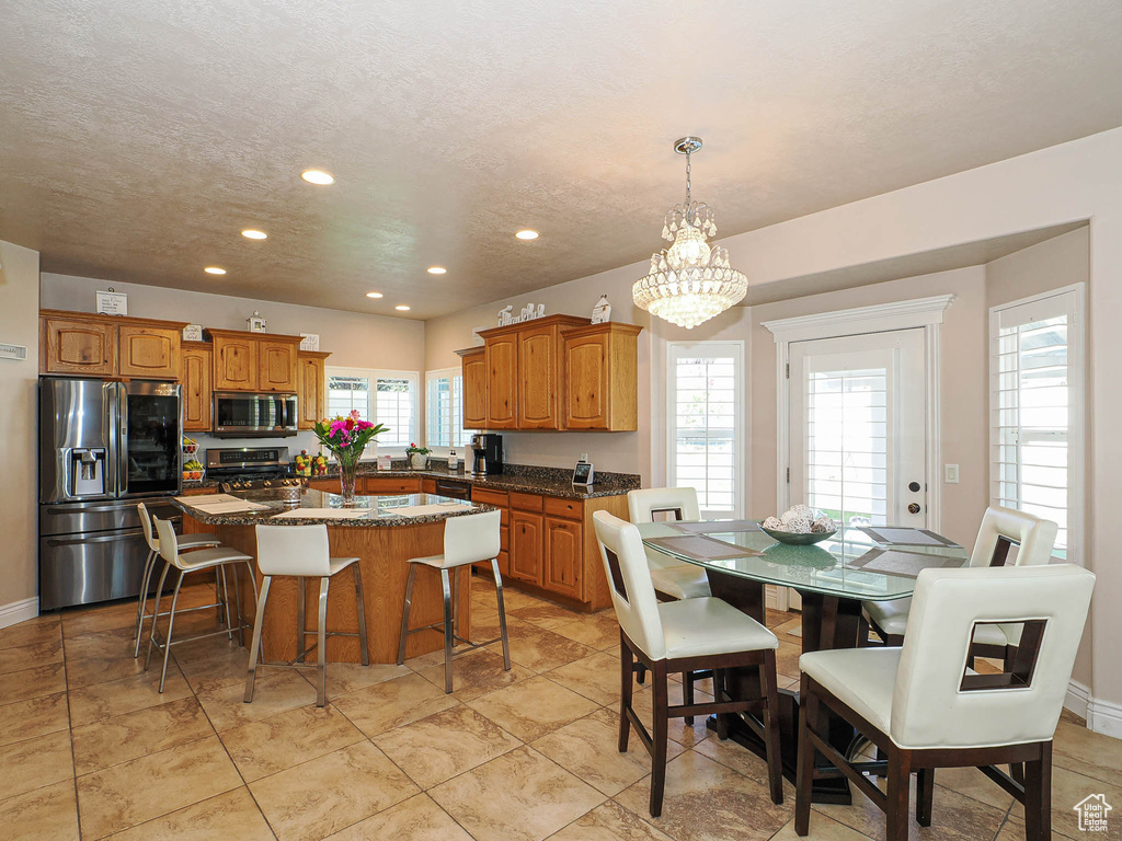 Dining space featuring recessed lighting and a chandelier