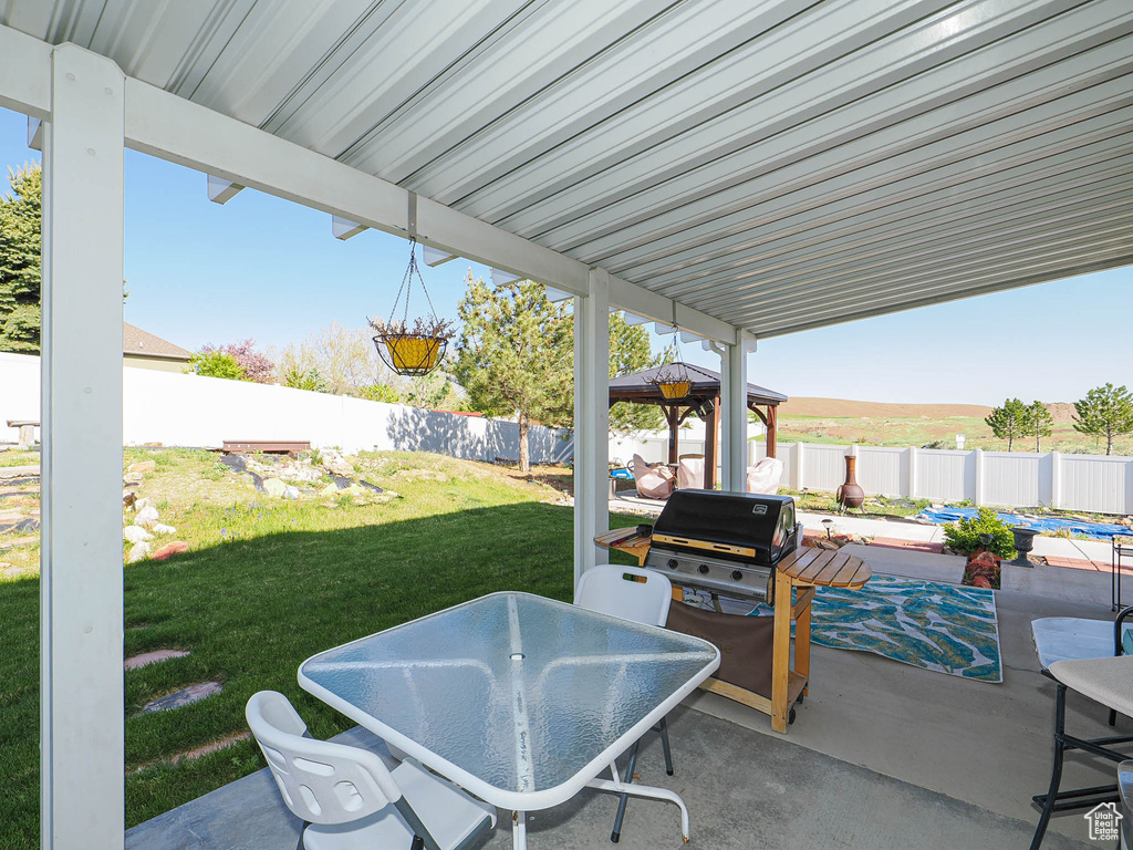 View of patio / terrace featuring outdoor dining area, a gazebo, and a grill