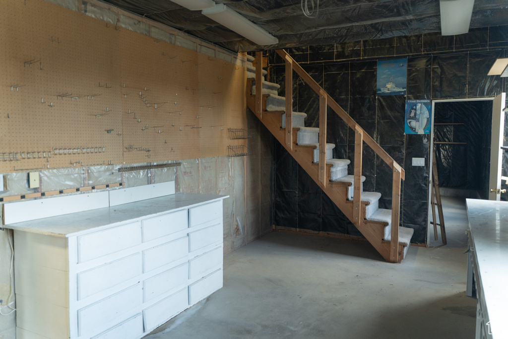 Unfinished basement featuring stairway