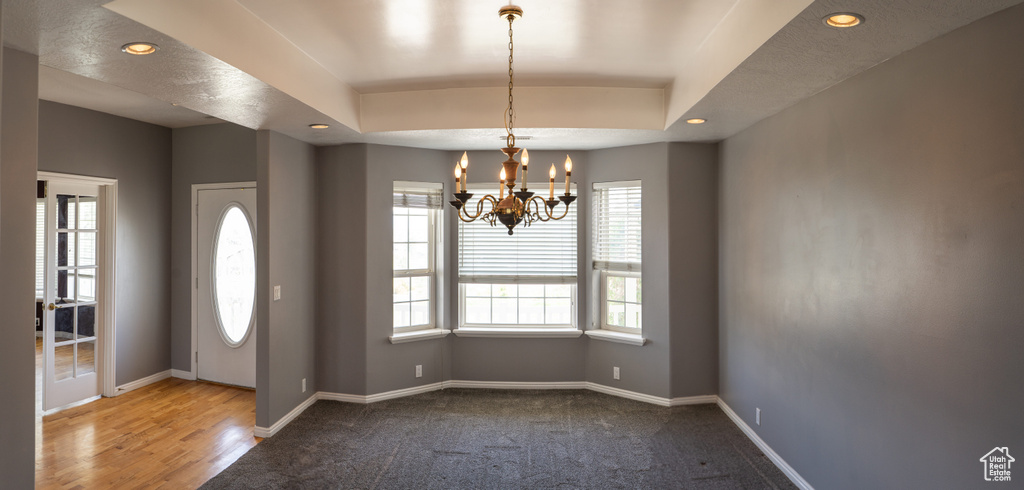 Foyer entrance with plenty of natural light, a chandelier, baseboards, recessed lighting, and carpet flooring