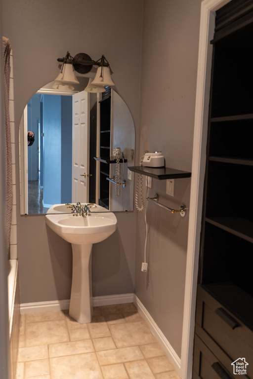 Bathroom with baseboards and a bath