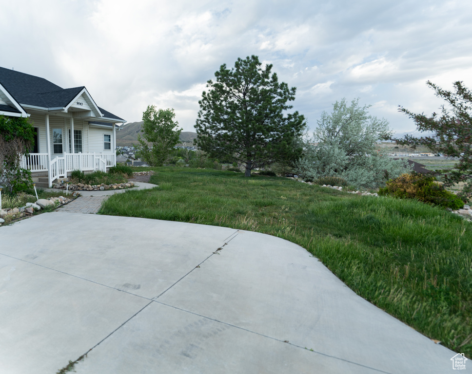 View of yard with covered porch and a patio area