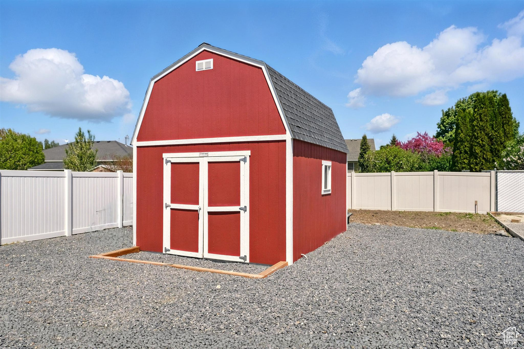 View of shed with a fenced backyard