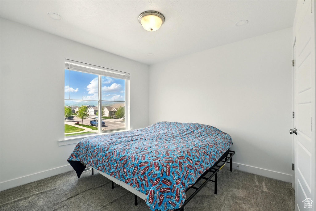 Bedroom with carpet flooring and baseboards