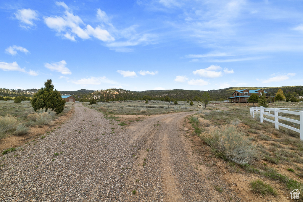 View of dirt / gravel driveway featuring a view of rural / pastoral area