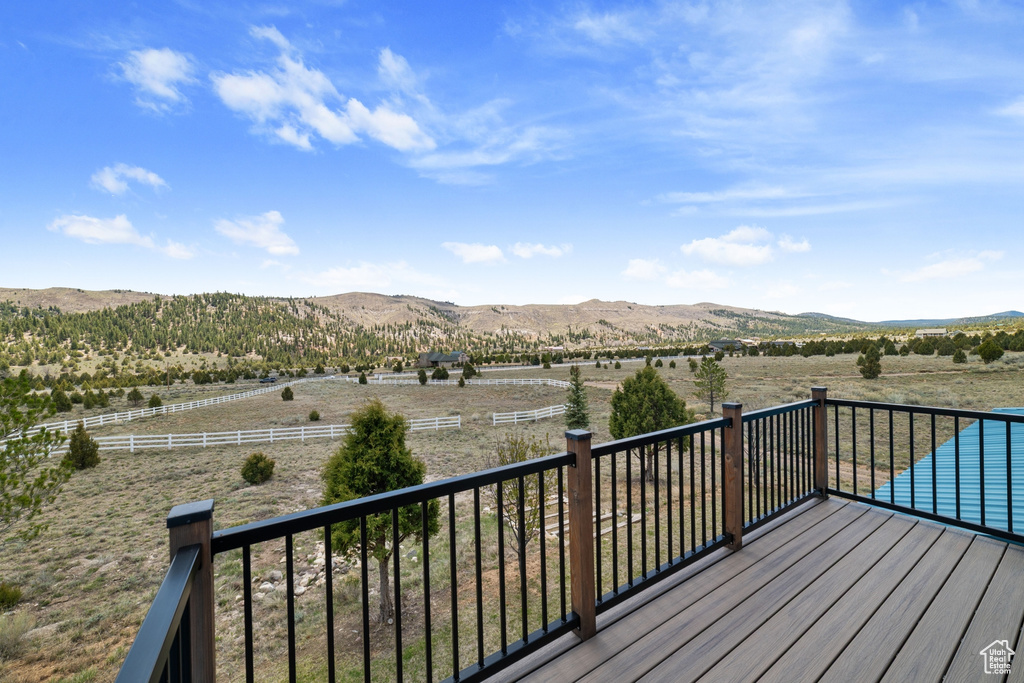 Wooden deck featuring a mountain view and a rural view